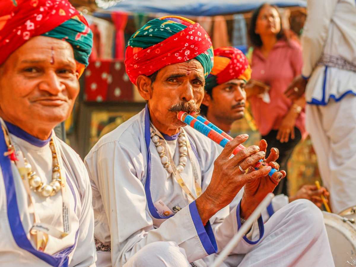 Three men gathered in traditional clothing in Bikaner, India.