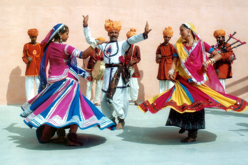 Men and women dancing in traditional dress at Mount Abu festival in India