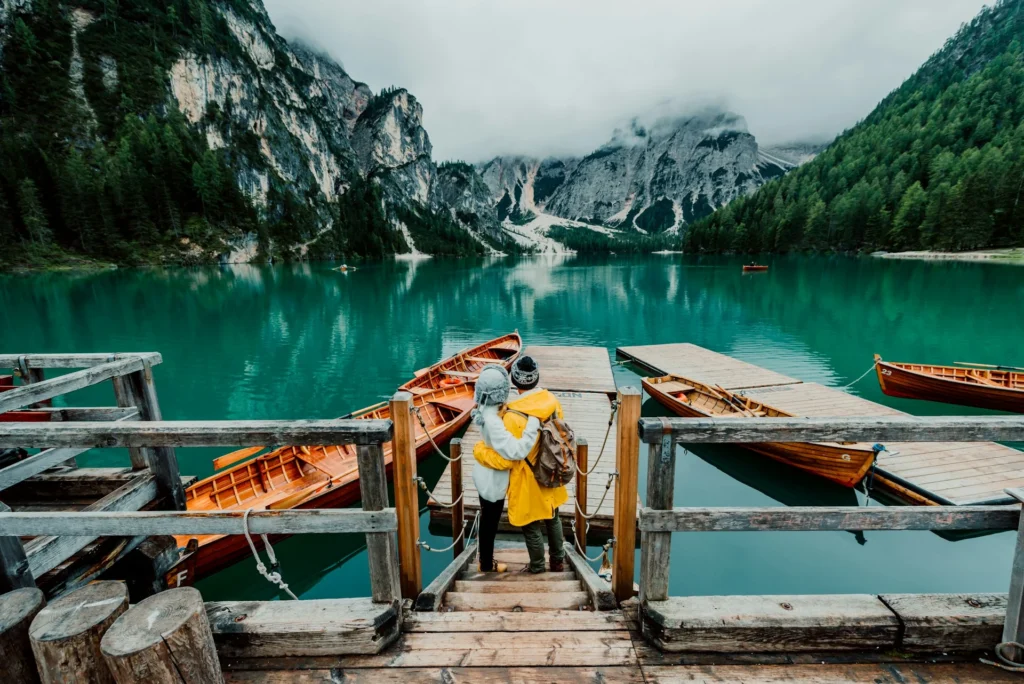 Couple looking out at boats surrounded by mountains