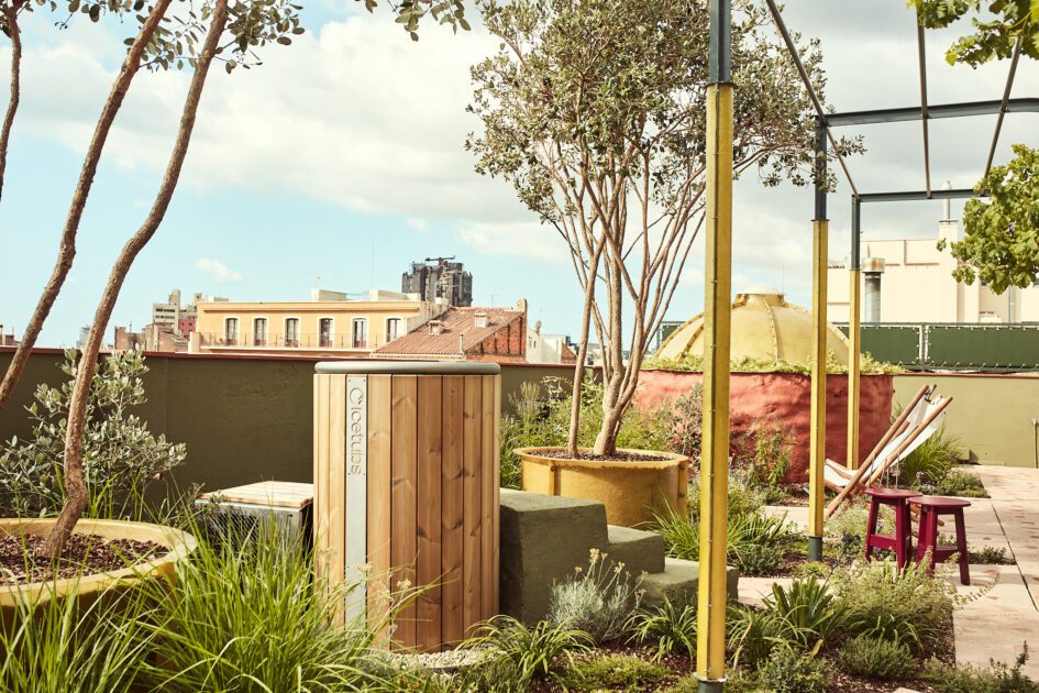 View of the rooftop wellness space at Termas Bonay with trees and wooden treatment stations.