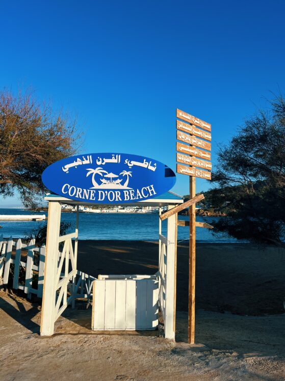 Corne d’Or Beach entrance sign in Arabic and French