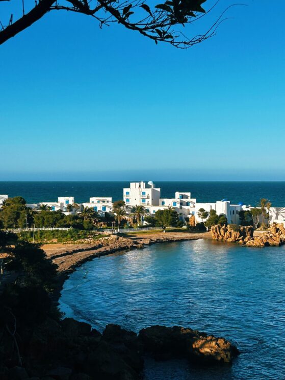 Wide coastal bay view with white buildings and sea